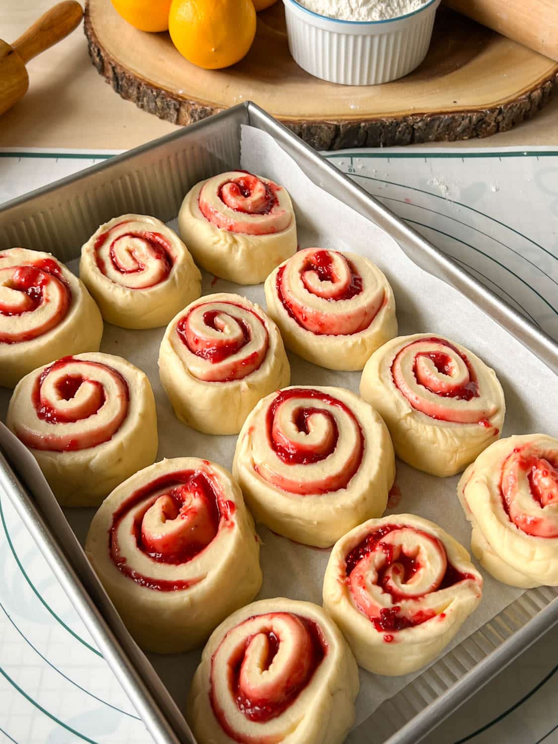 Unbaked raspberry lemon rolls in a pan