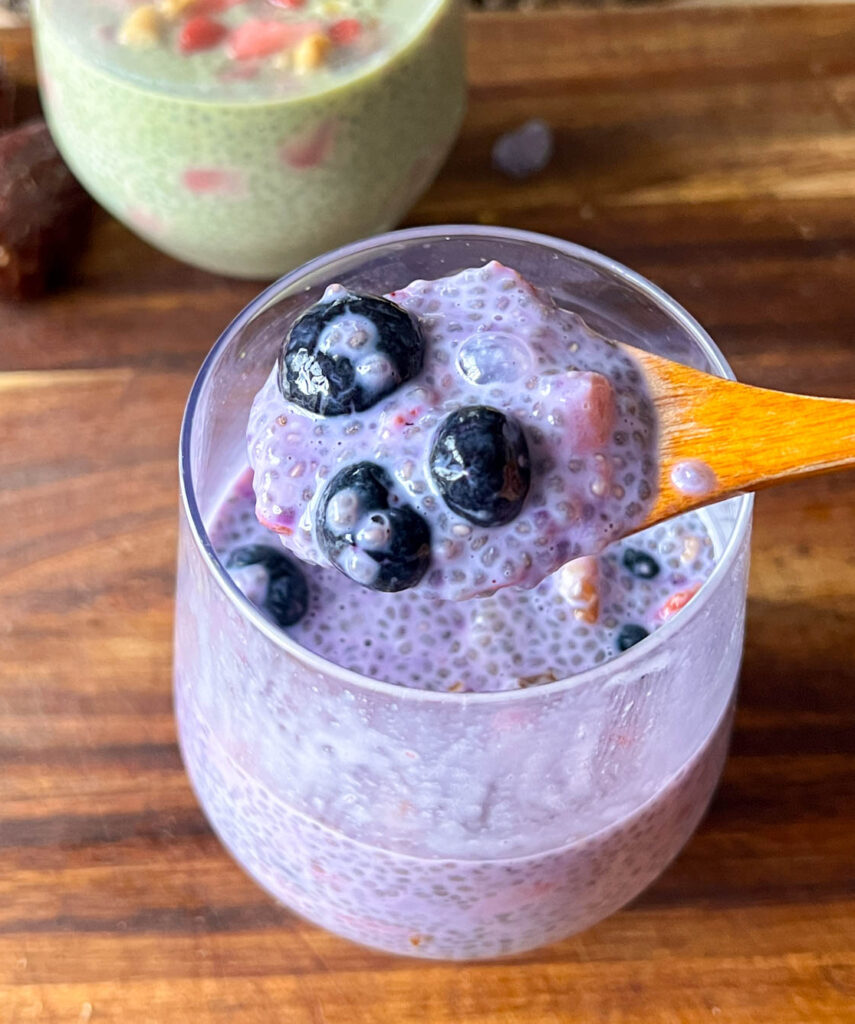 Berry chia pudding on a small wooden spoon 