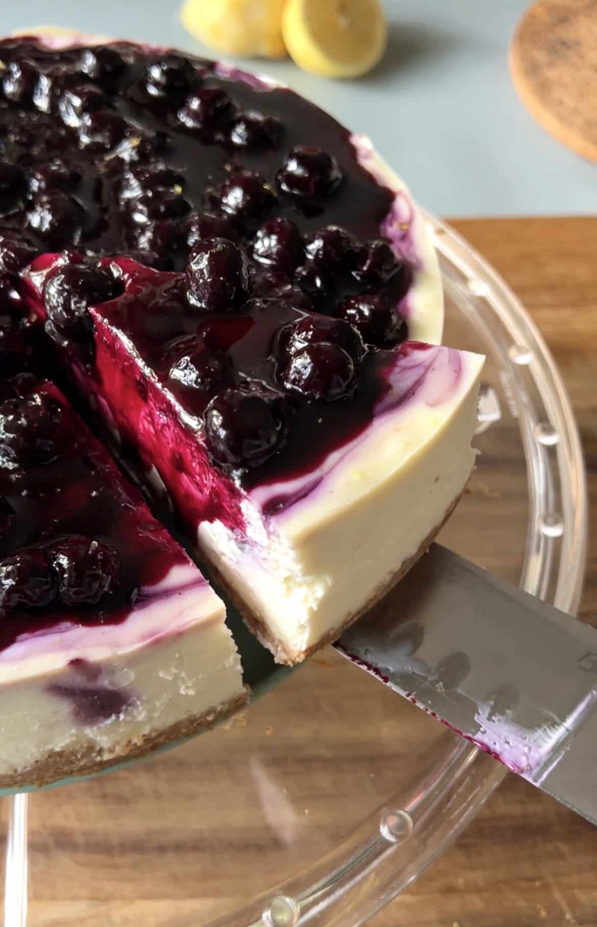 a slice of blueberry lemon cheesecake being taken out