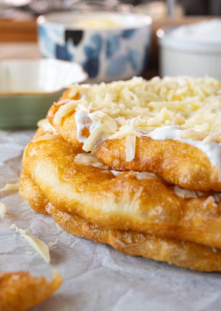 a stack of langos (hungarian fried flatbread) with cheese