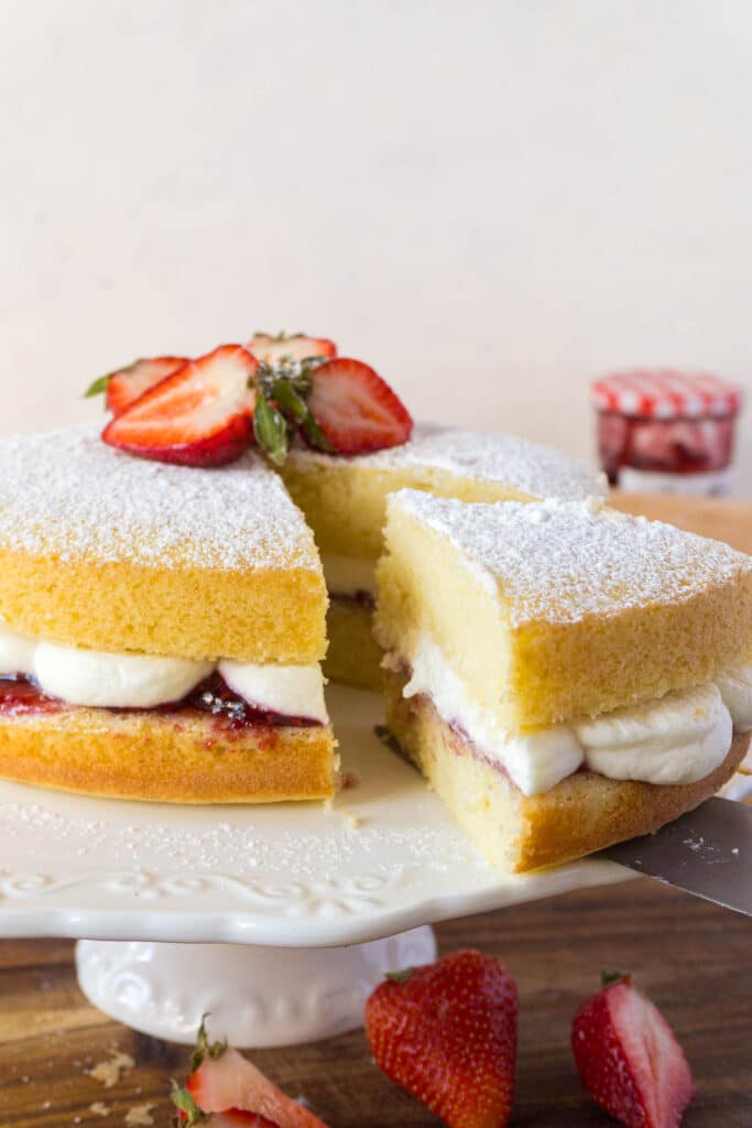 victoria sponge cake with a slice cut 