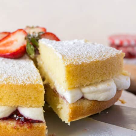 victoria sponge cake with a slice cut