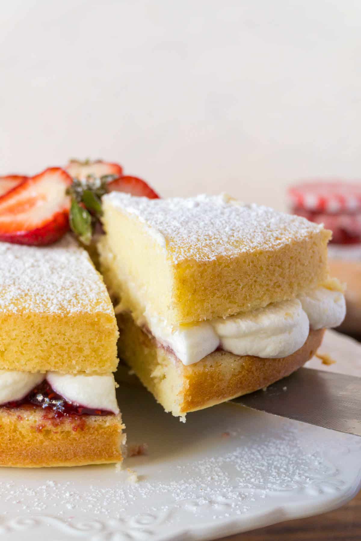 victoria sponge cake with a slice cut