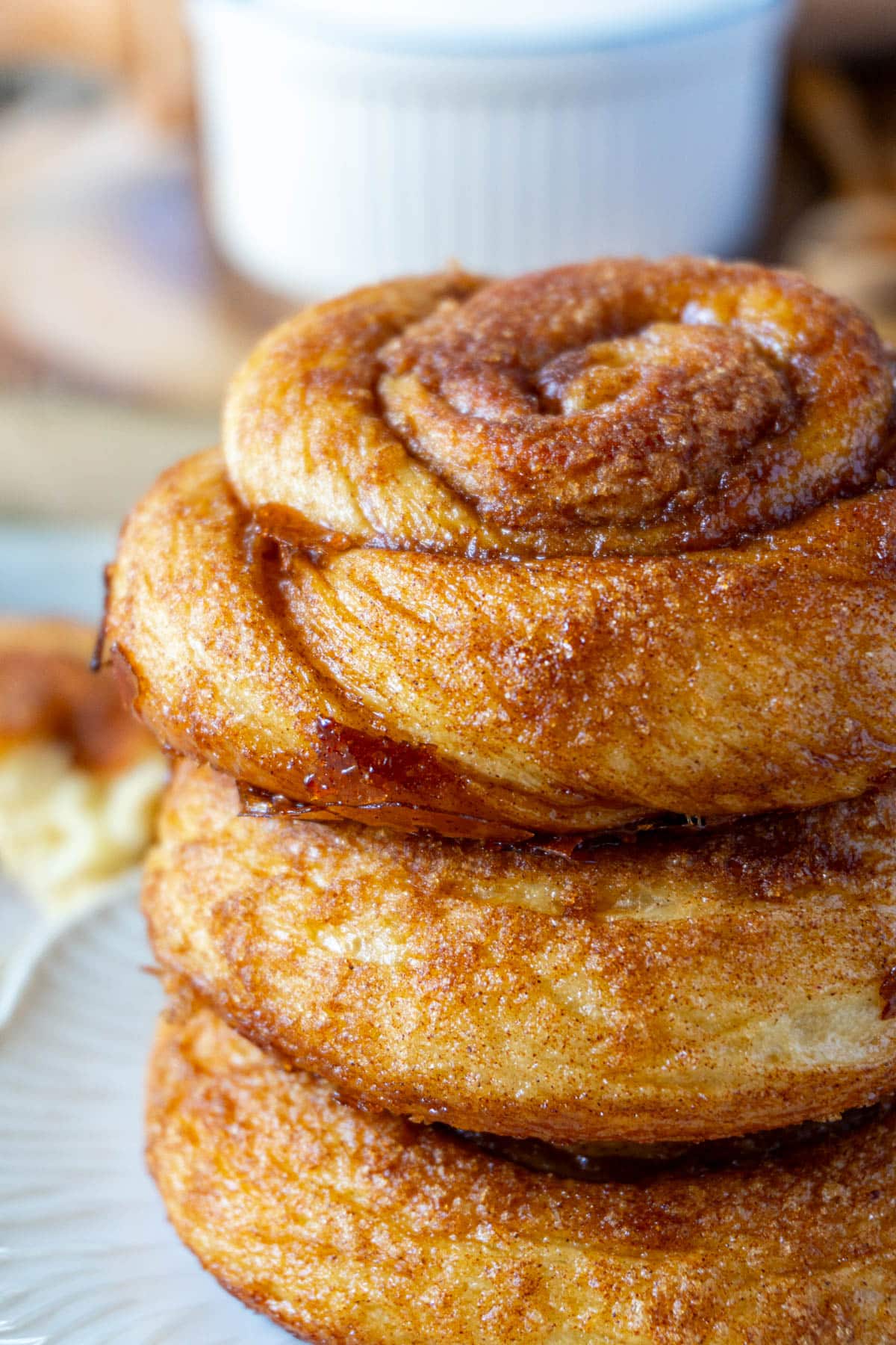 3 dutch cinnamon rolls stacked on a white plate