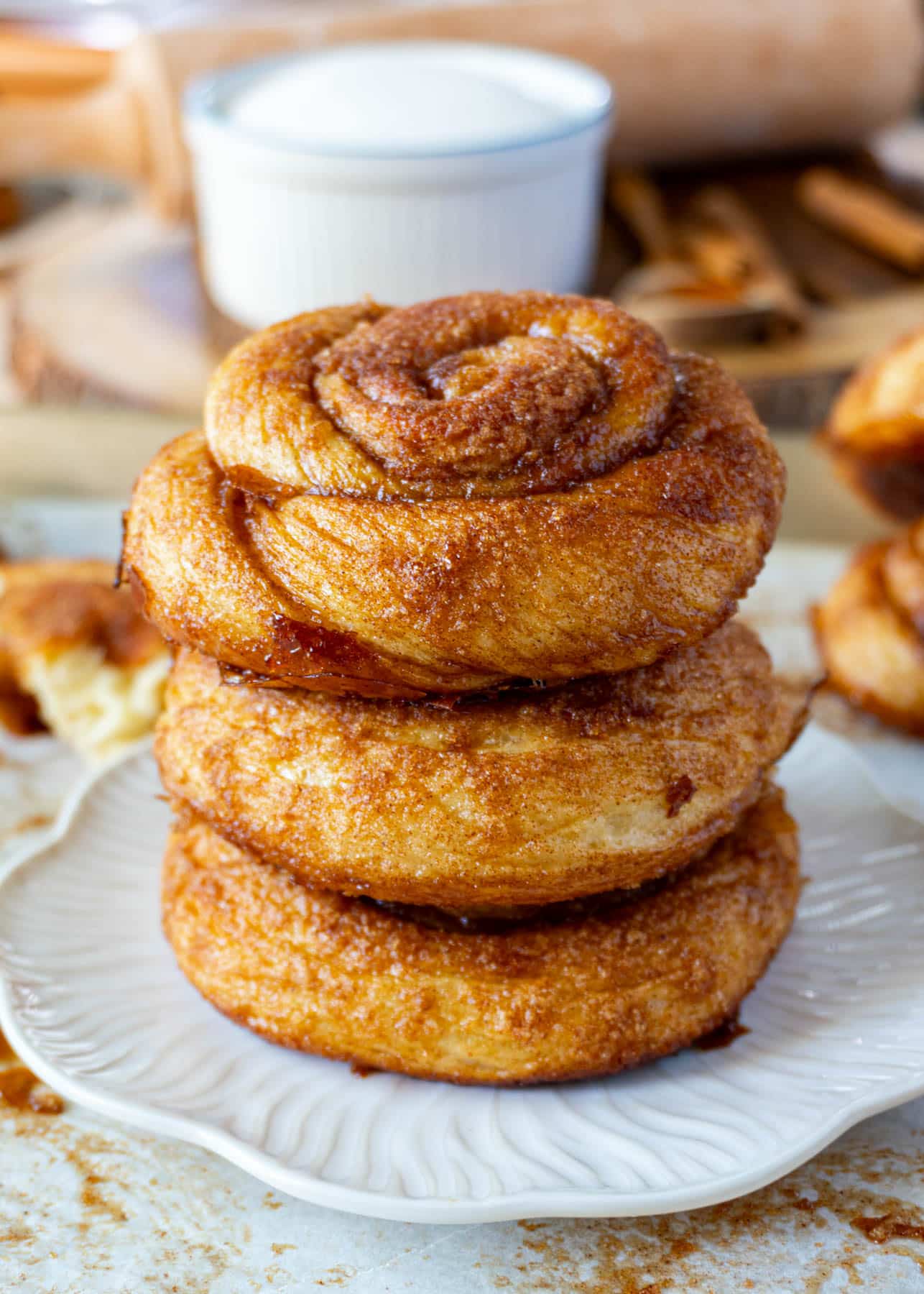 3 dutch cinnamon rolls stacked on a white plate