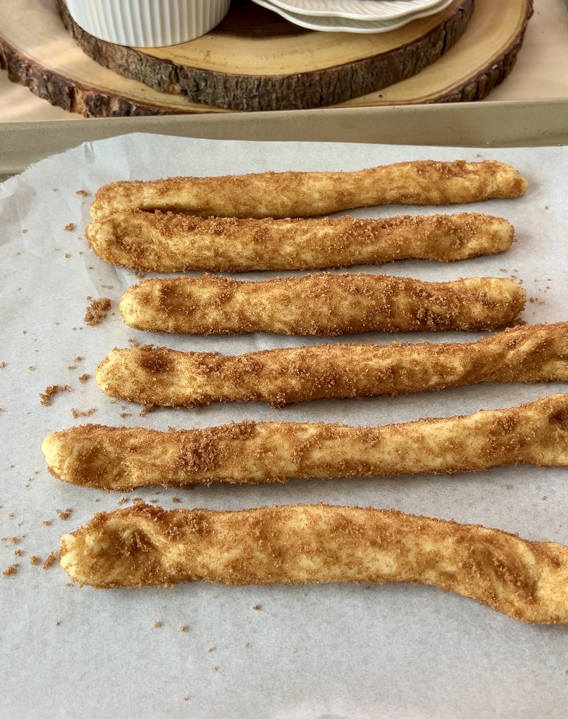 dough rolls covered with sugar on a pan