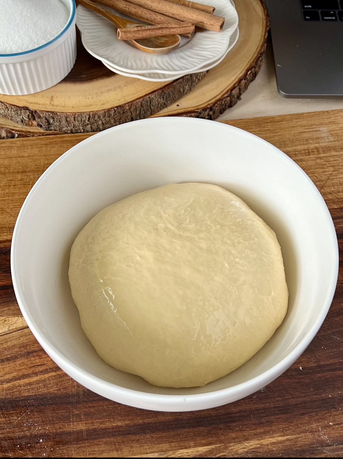 A ball of dough in a white bowl