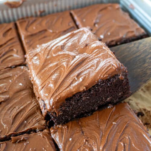 a slice of chocolate sheet cake being lifted from a pan