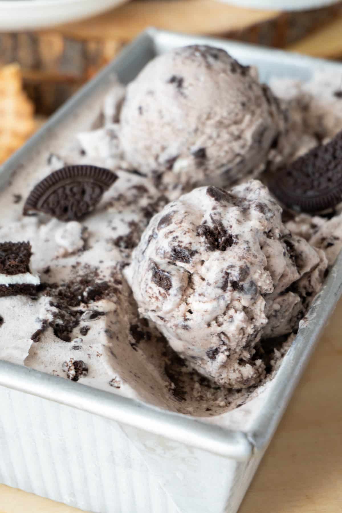 two scoops of cookies and cream ice cream in a container 