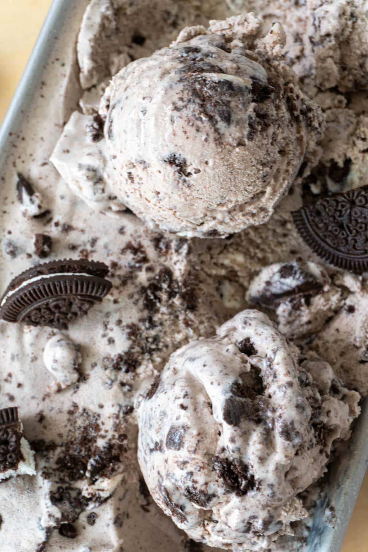 two scoops of cookies and cream ice cream in a container