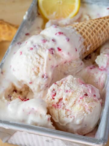 ice cream in a cone, with a scoop in the container