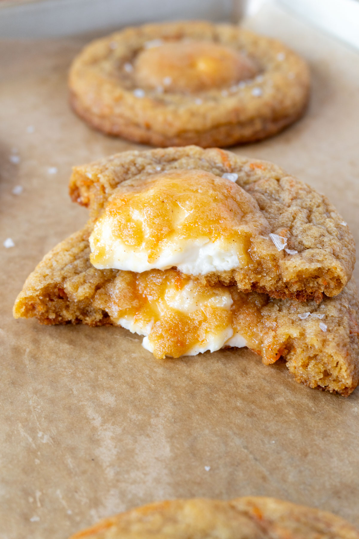 a stuffed carrot cake cookie in half, stacked