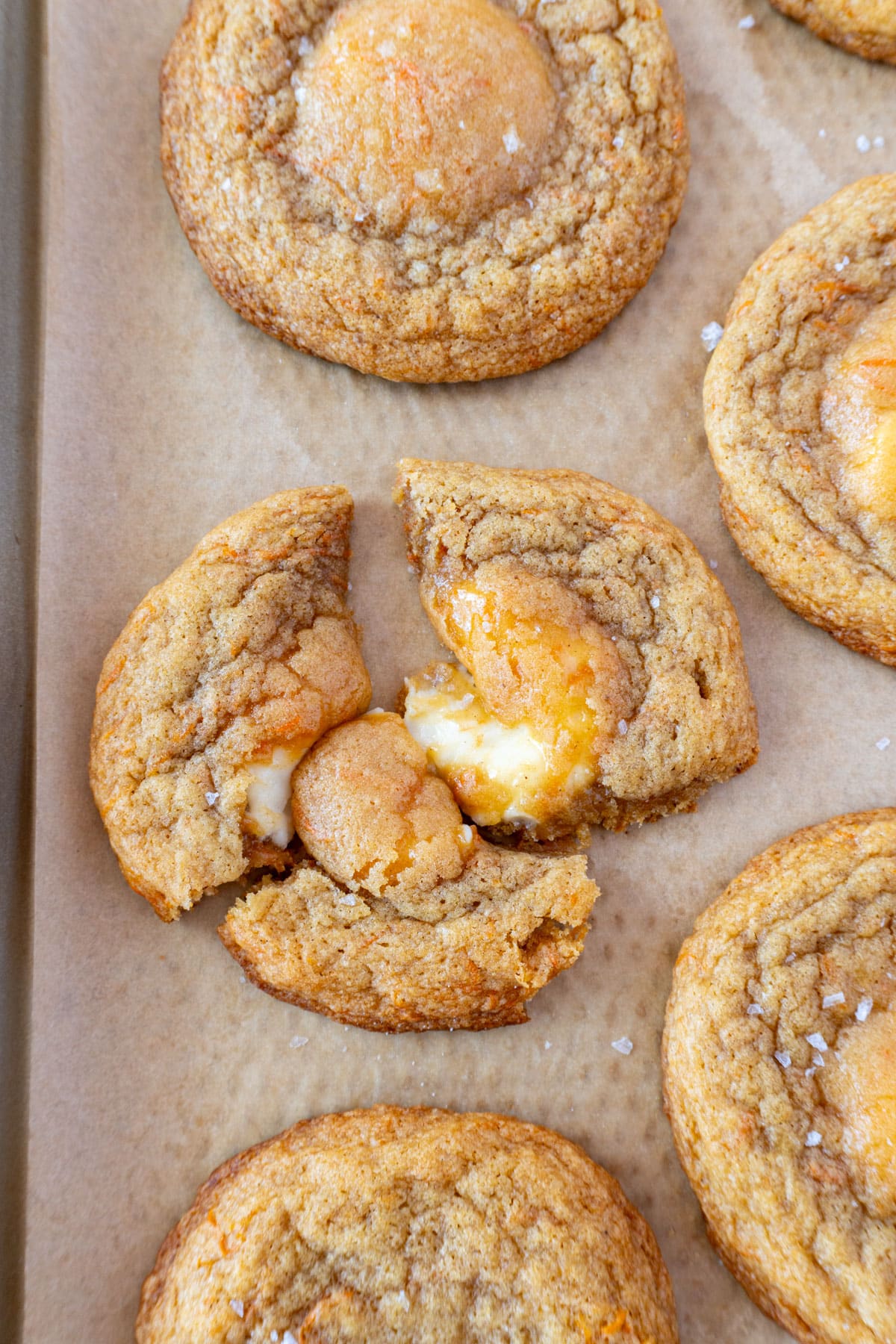 carrot cake cookies on a pan, lined with brown parchment paper