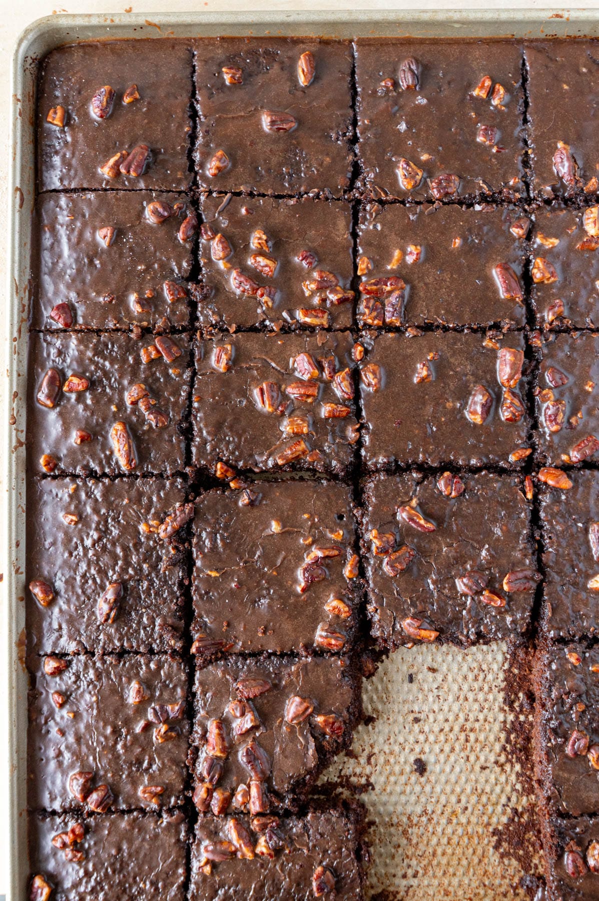 texas sheet cake in a pan, cut into pieces