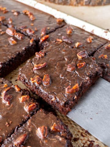 a slice of texas chocolate sheet cake being lifted from a pan