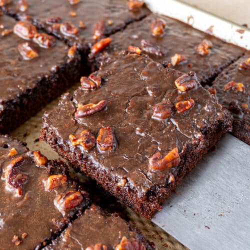 a slice of texas chocolate sheet cake being lifted from a pan