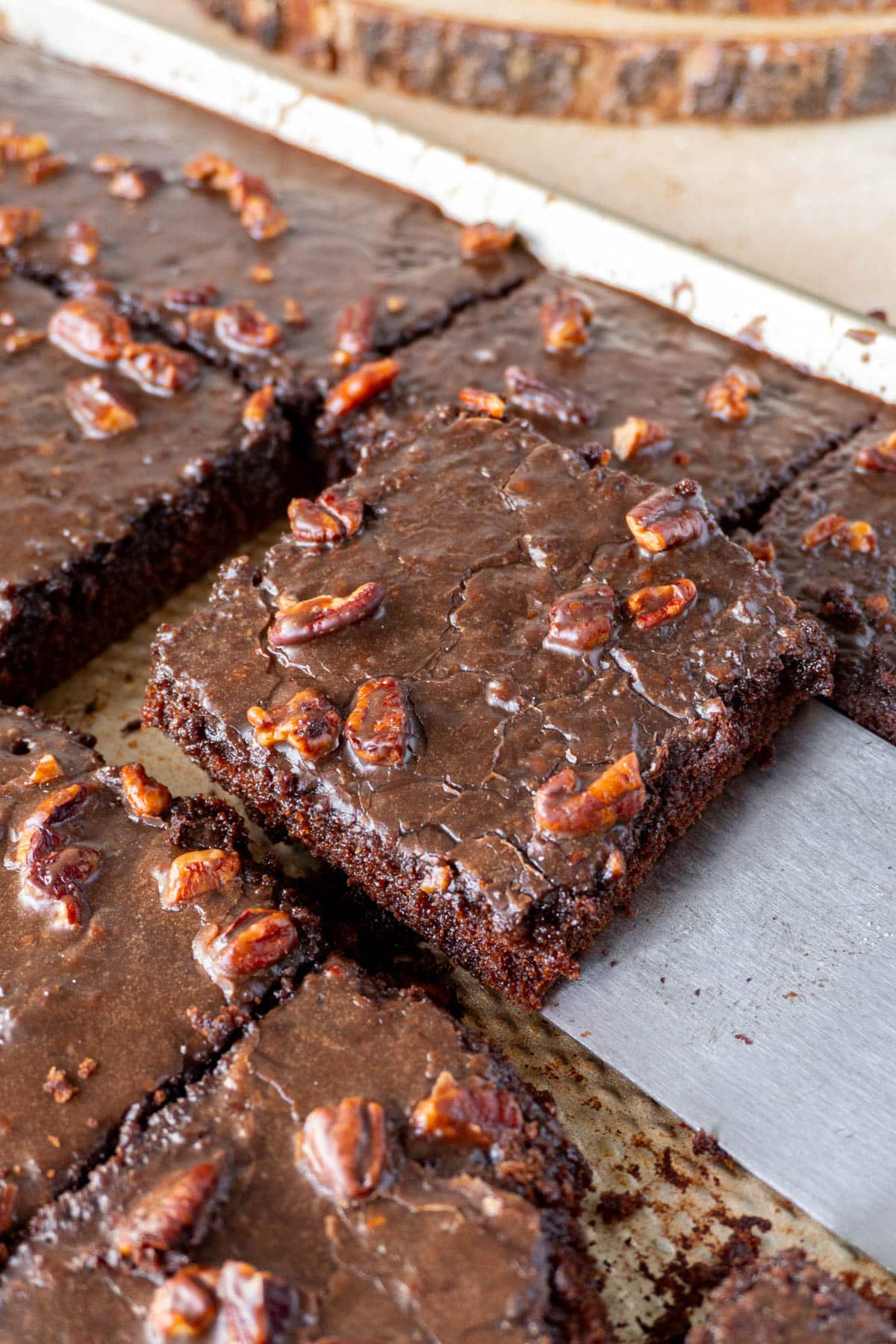 a slice of texas chocolate sheet cake being lifted from a pan