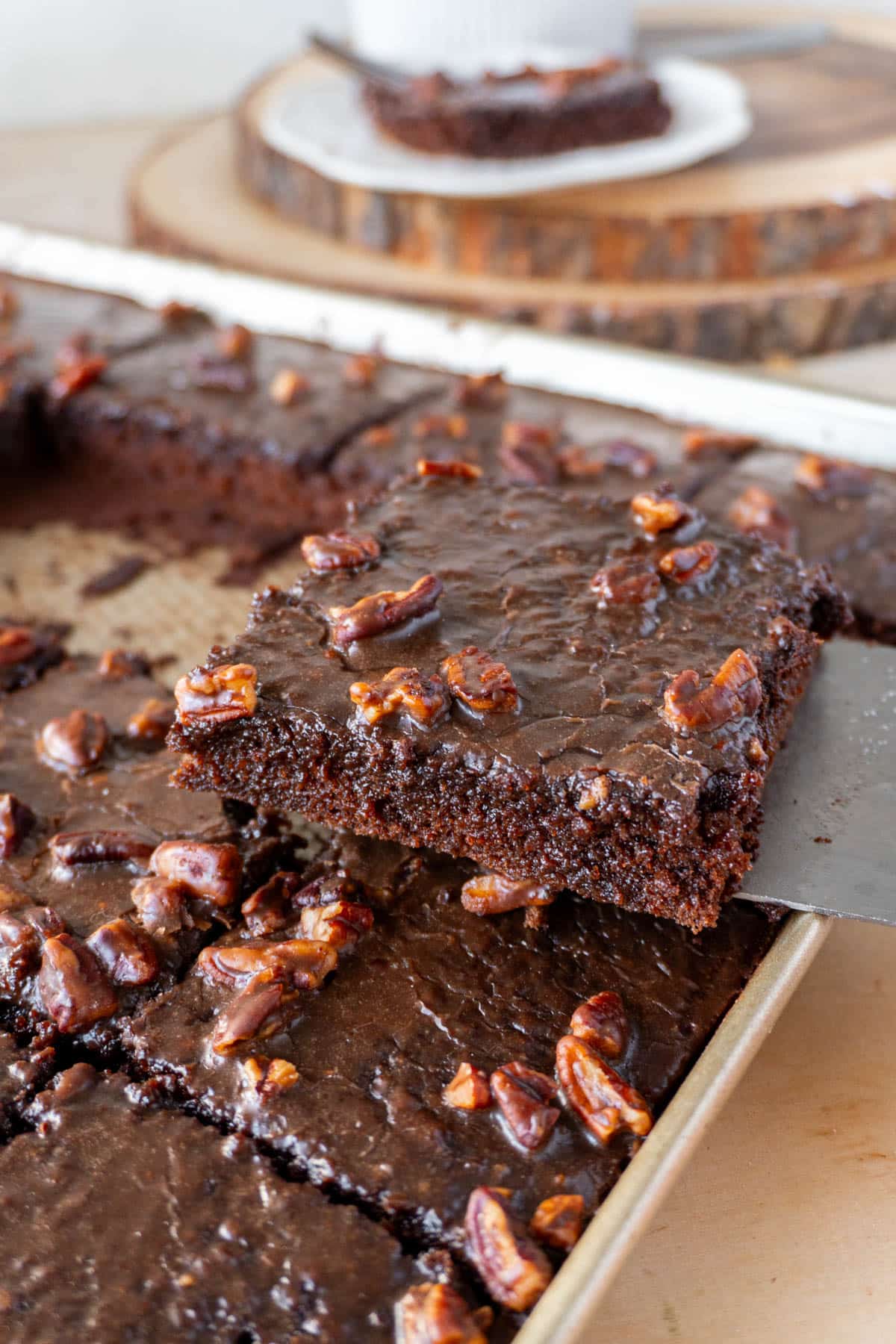 a slice of texas chocolate sheet cake being lifted from a pan