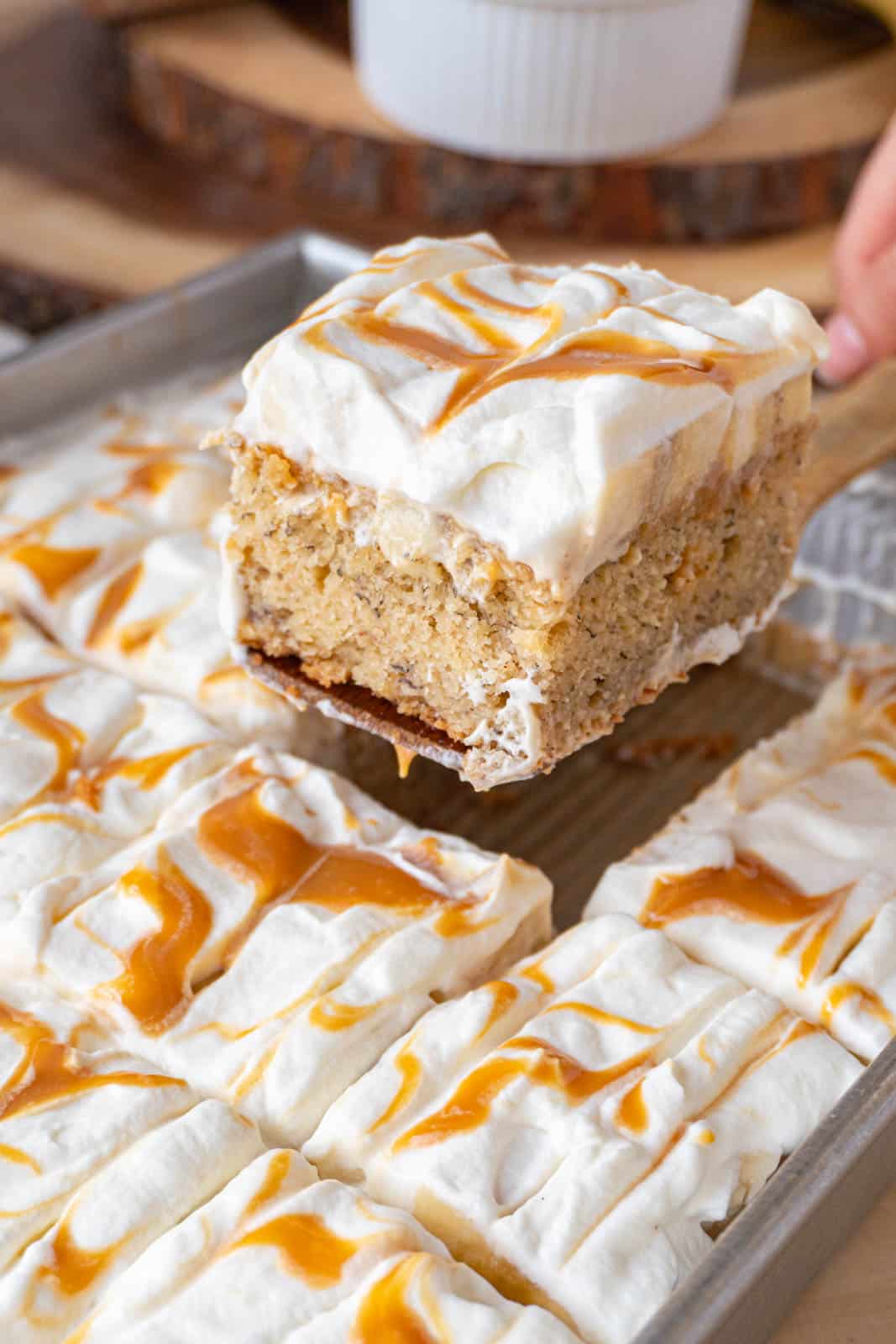 banoffee cake slice being taken out of the pan