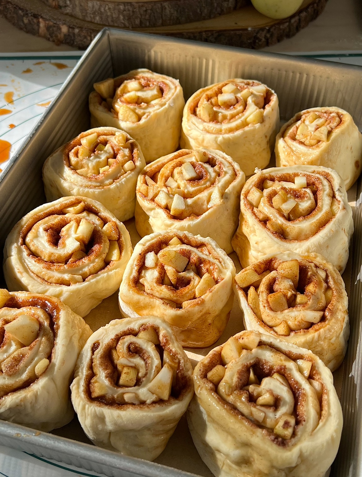 apple pie cinnamon rolls cut and placed in pan