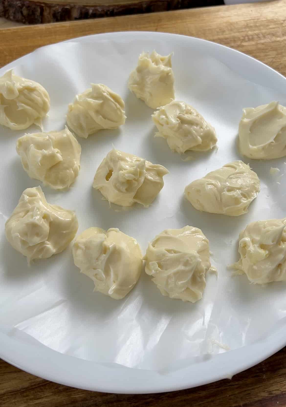 Dollops of cream cheese filling on a white plate