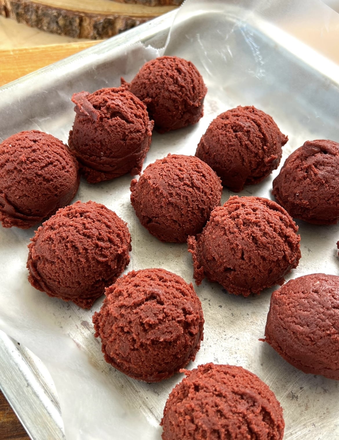 11 Red velvet cookie balls on a tray