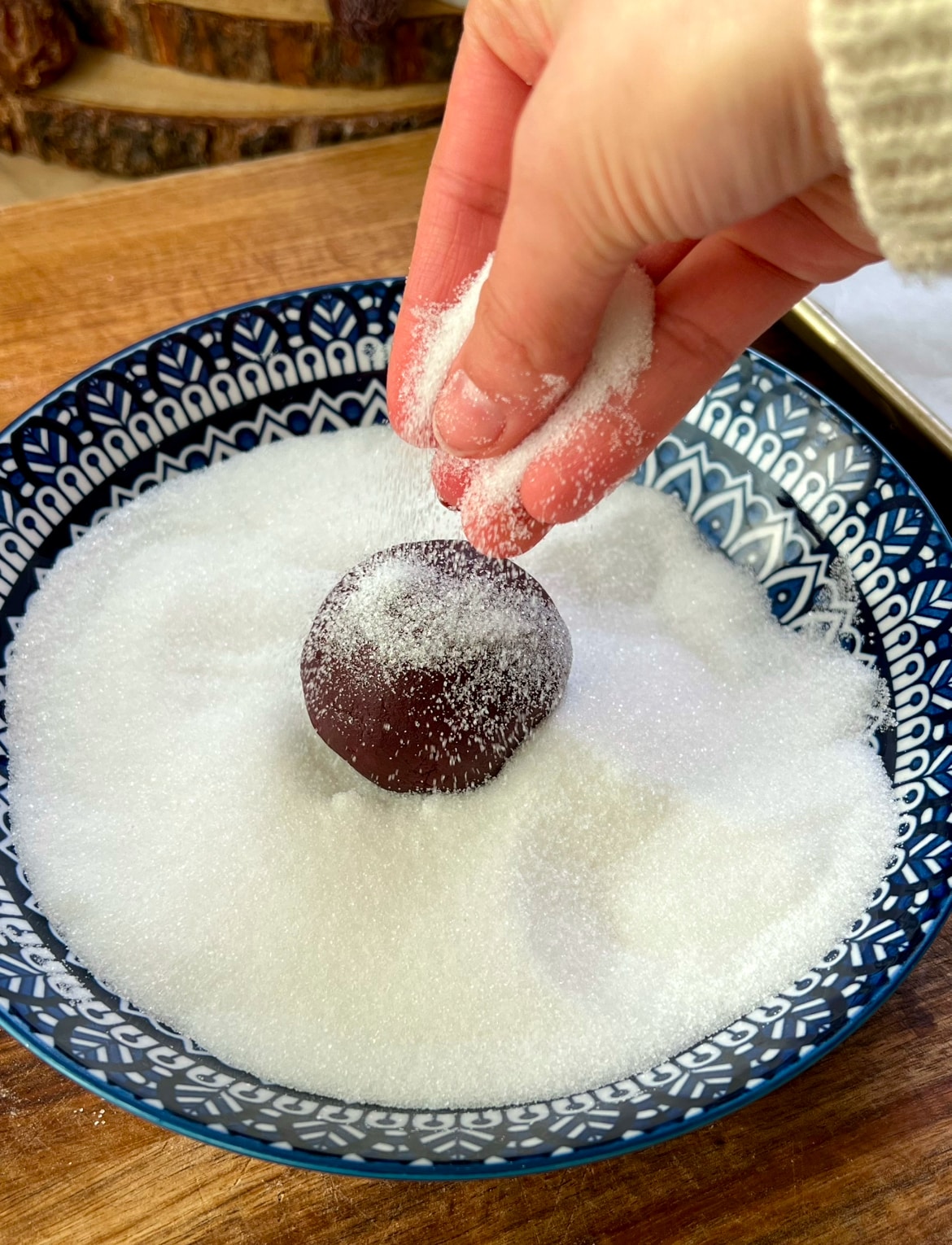 Cookie ball being covered in sugar