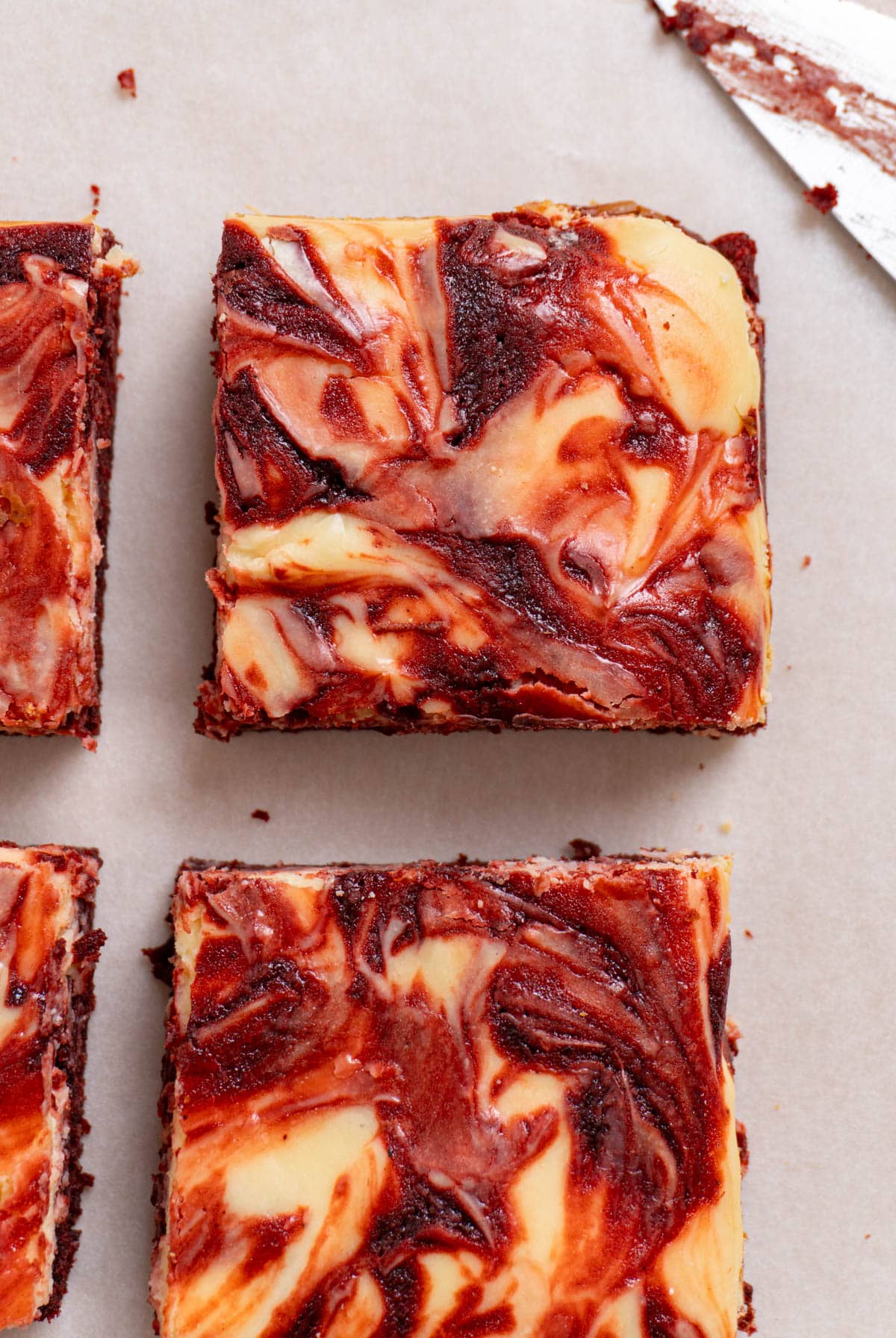  red velvet cheesecake brownies on a white surface