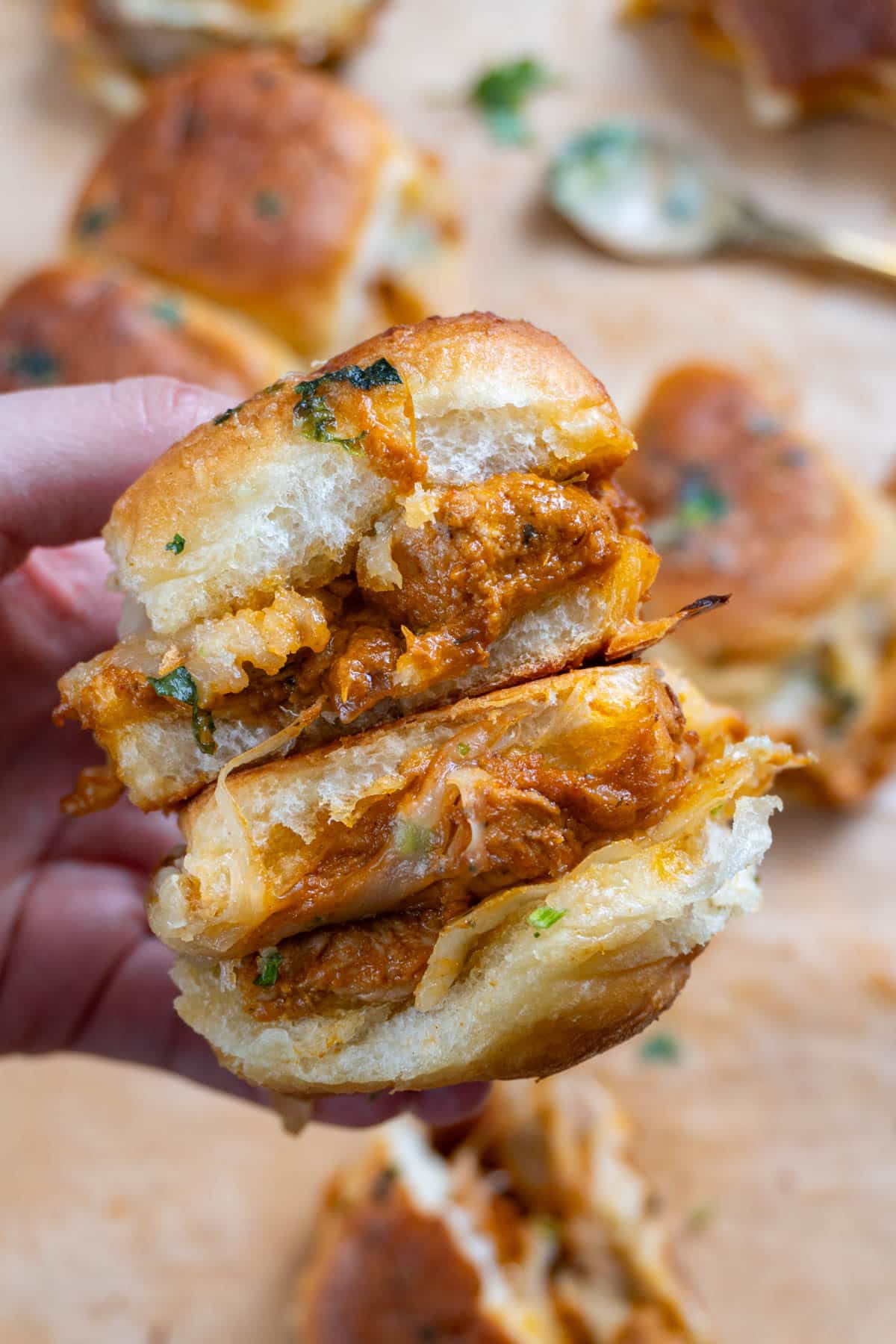 holding two butter chicken rolls