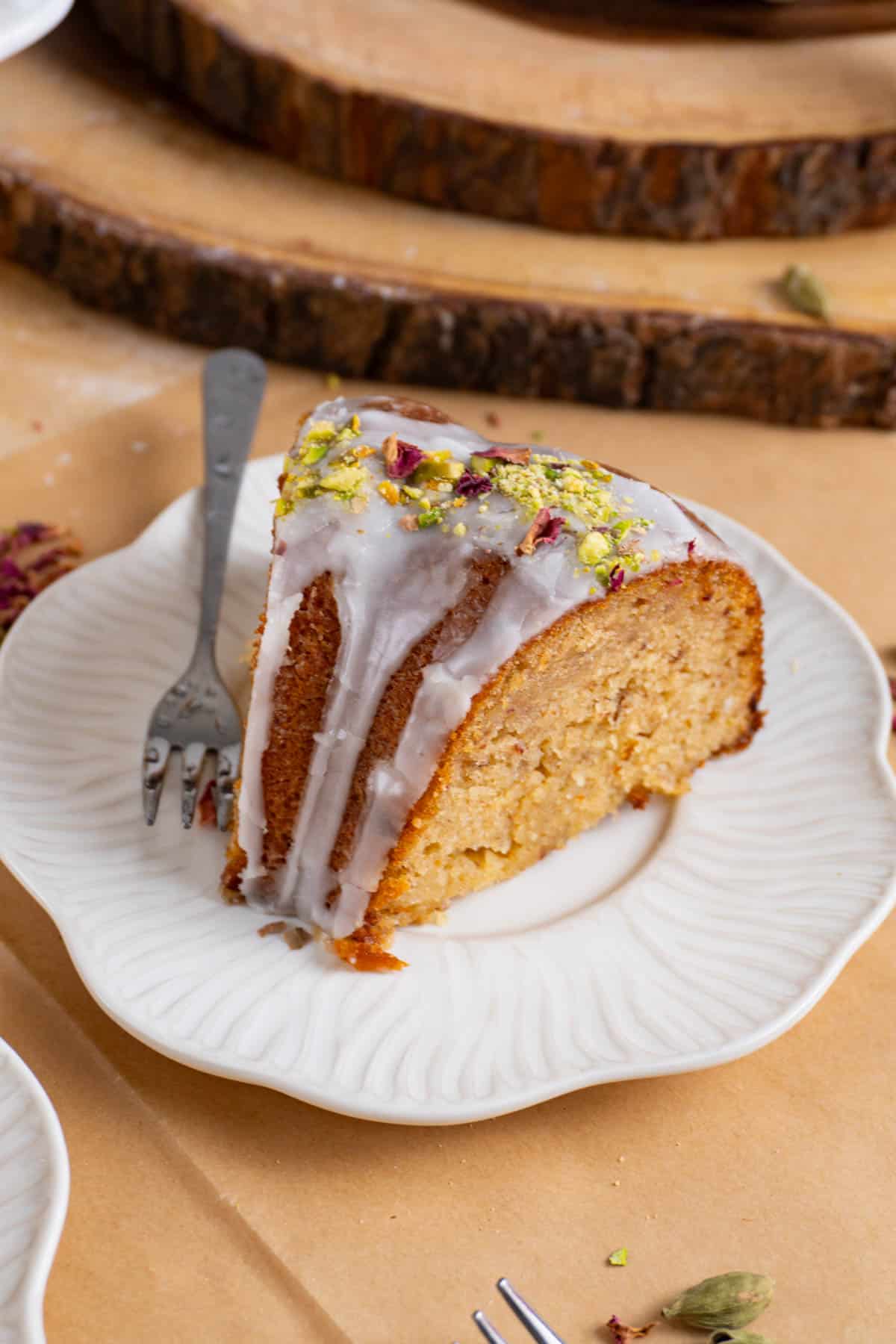 A slice of gulab jamun cake on a white plate