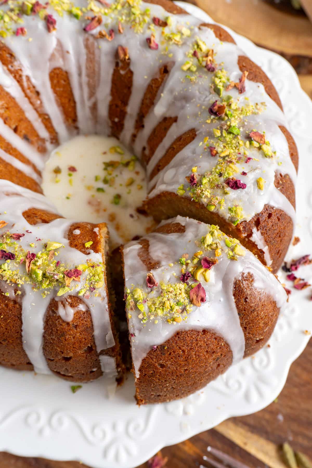 Gulab jamun date cake with a cut slice slightly offset
