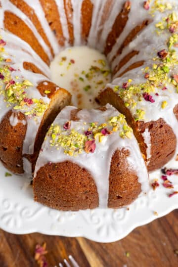 Gulab jamun date cake with a cut slice slightly offset