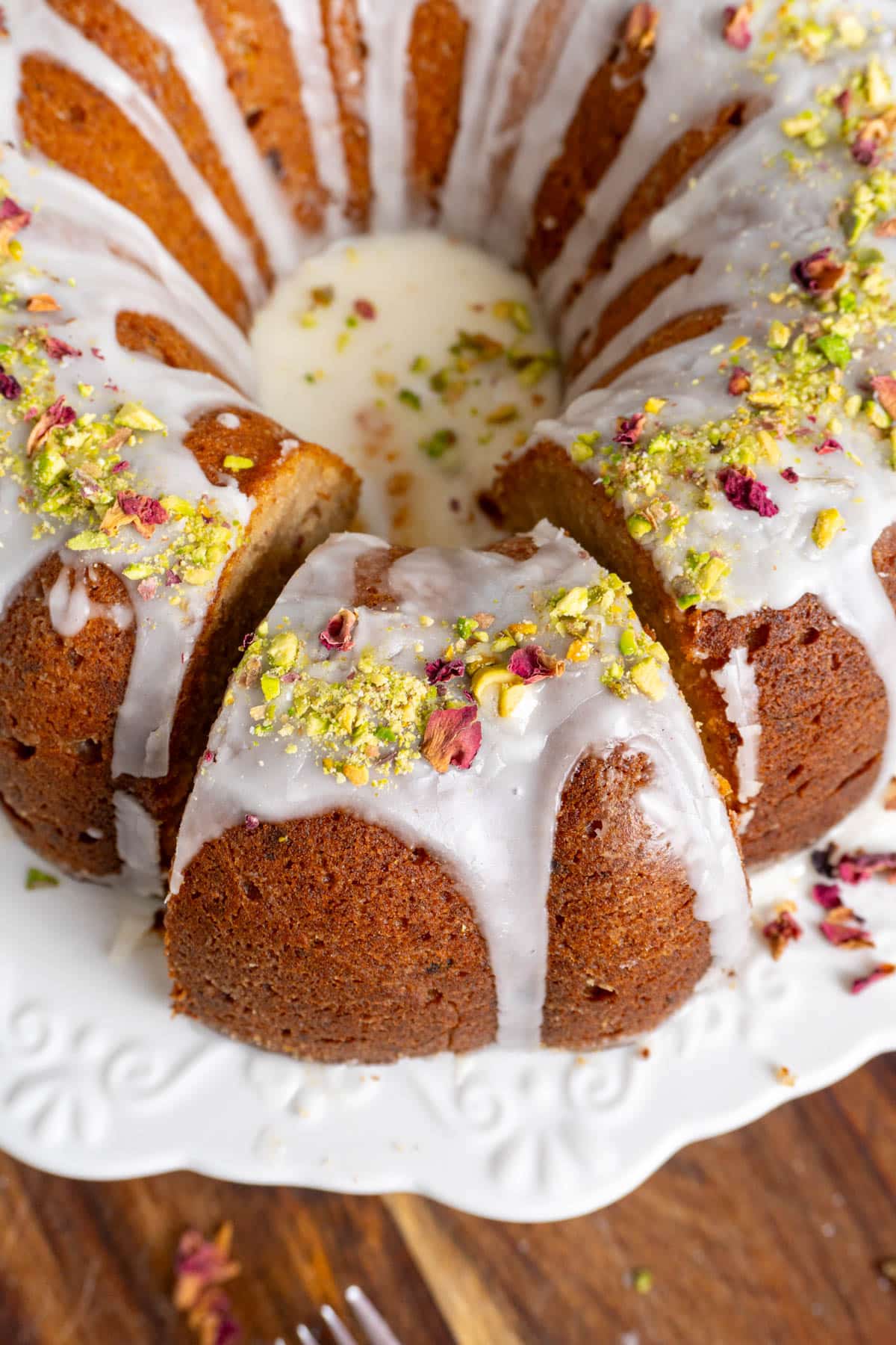 Gulab jamun date cake with a cut slice slightly offset