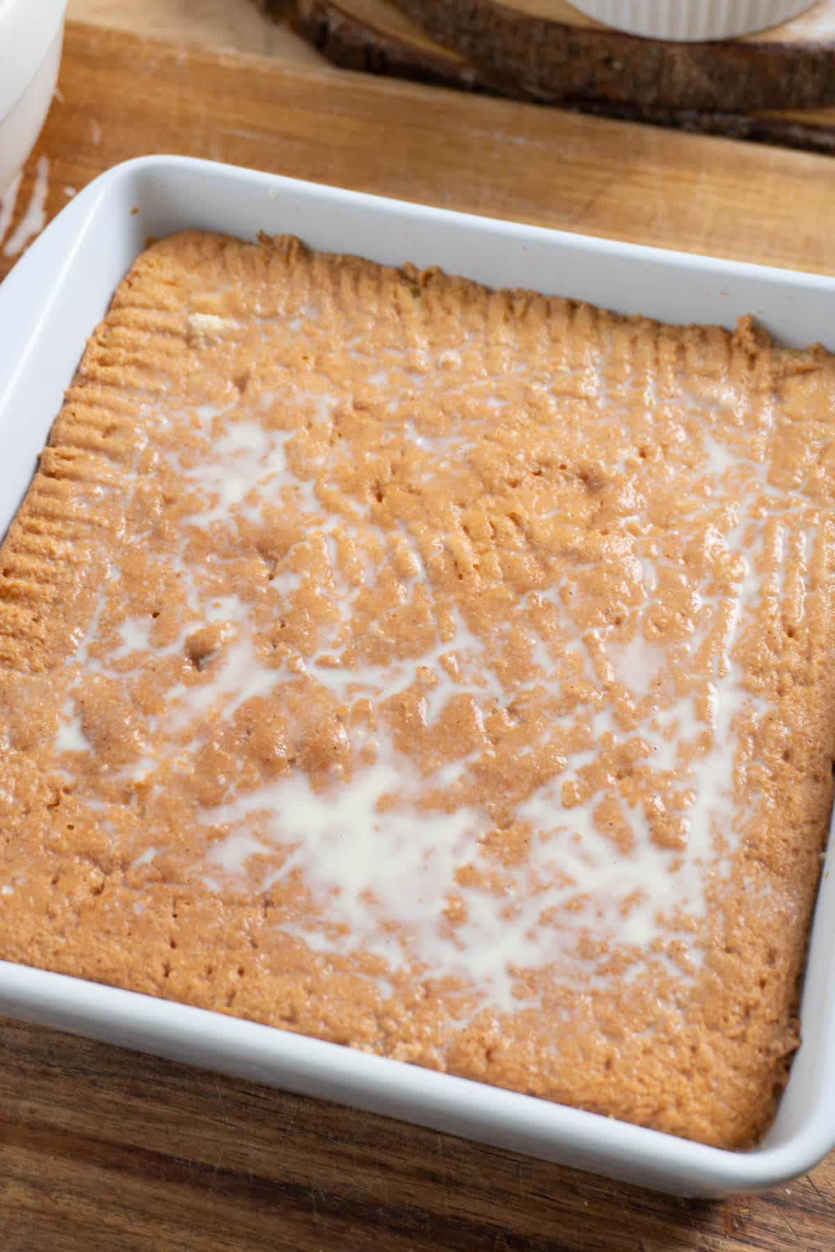 tres leches cake soaking in pan