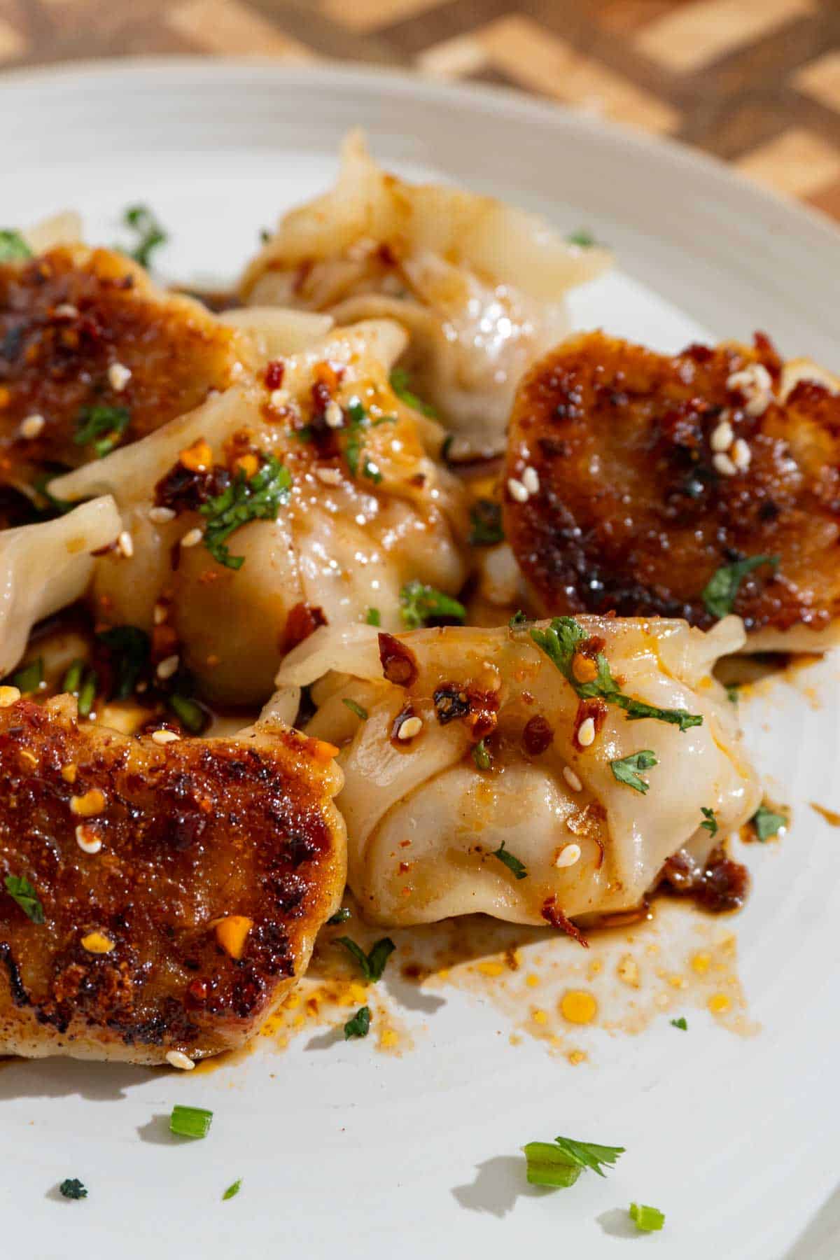 White plate with dumplings on it