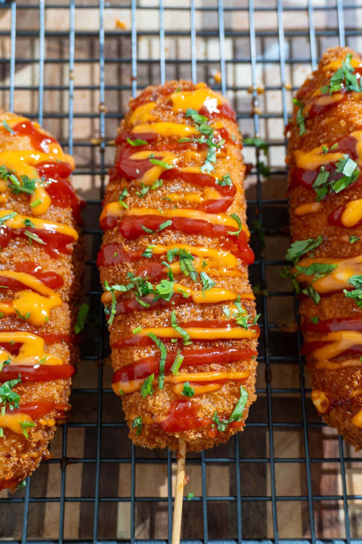 3 korean corn dogs on a wire rack